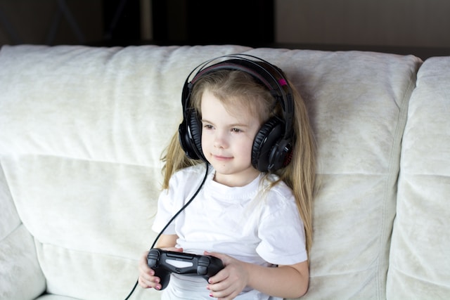 young girl playing PS4 game