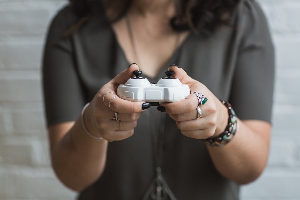 woman holding a video game console controller